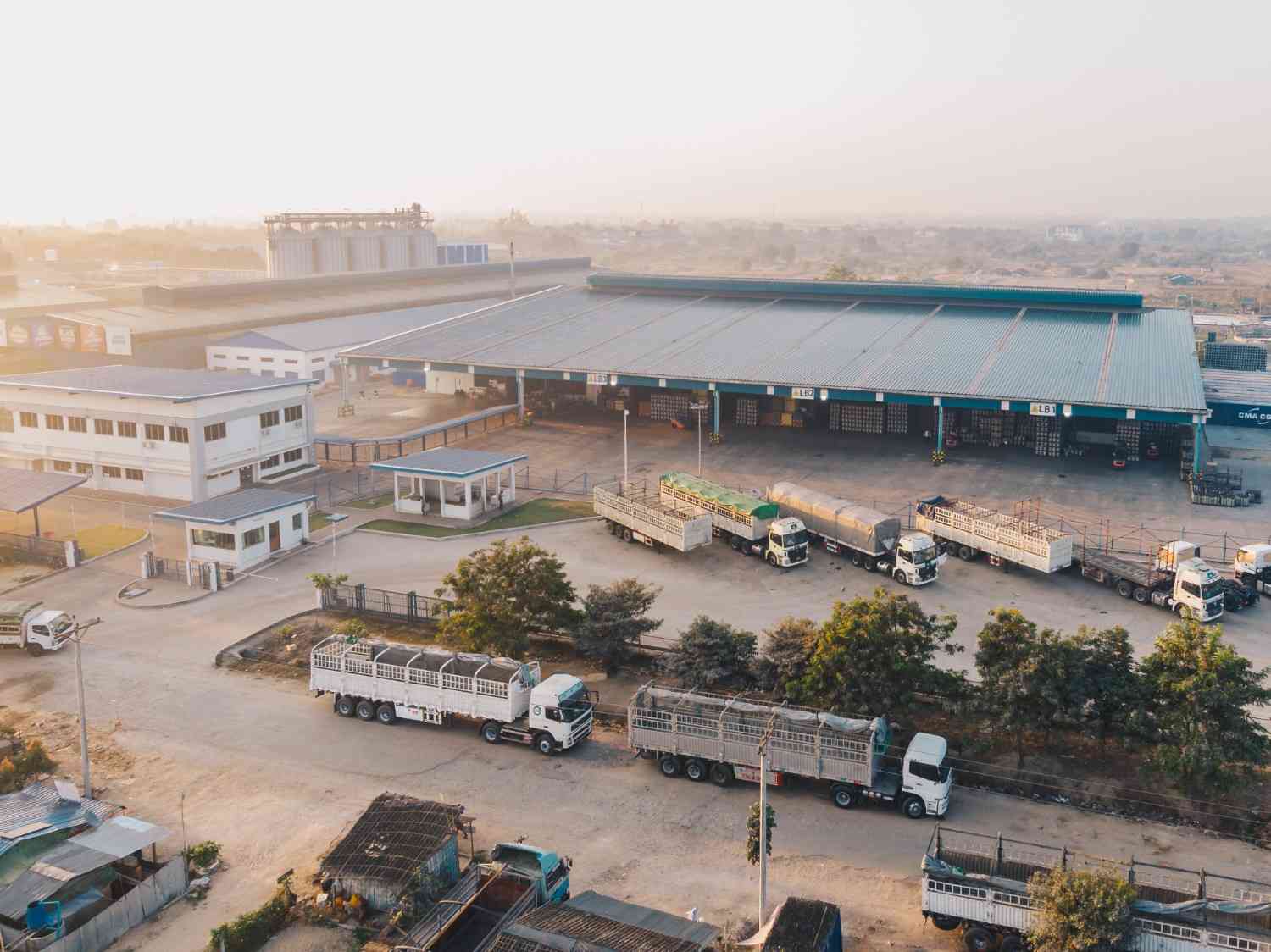 aerial view factory trucks parked near warehouse daytime (1)